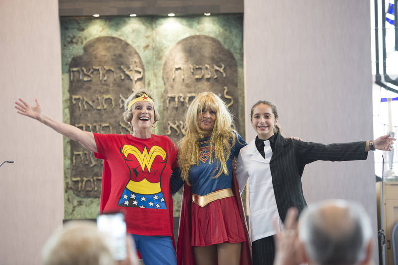 three performers in costume for the Purim shpiel in the Sanctuary
