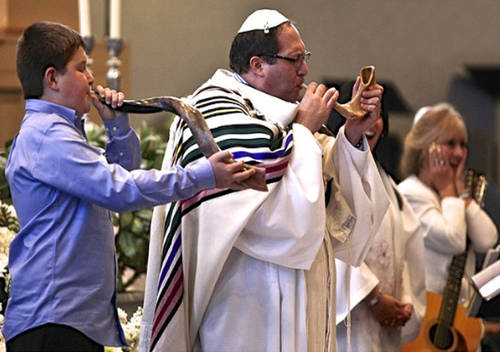 Rabbi Miller and student blow shofar