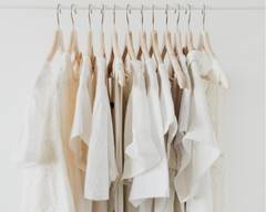 white clothing hanging on hangers