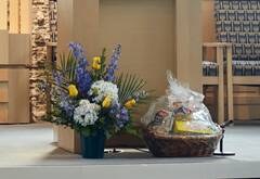 blue, yellow and white flower arrangement and mitzvah basket on the bimah