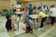 two students pack Meals of Hope in the multipurpose room