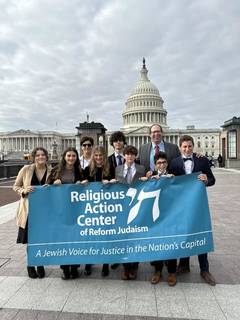Rabbi Miller and students at the Capitol in DC holding a banner for Religious Action Center of Reform Judaism